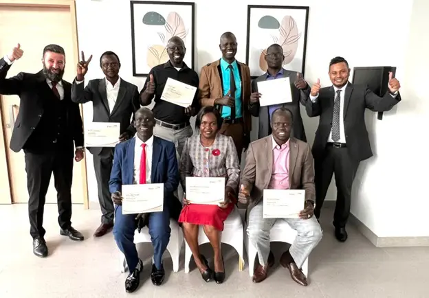 FreeBalance Academy students display their training certificates